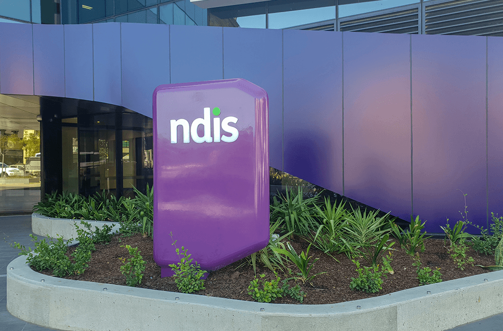 Photo of NDIS sign in garden outside NDIS building