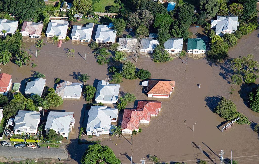 Bird's eye view of a flooded street of Queenslander homes.