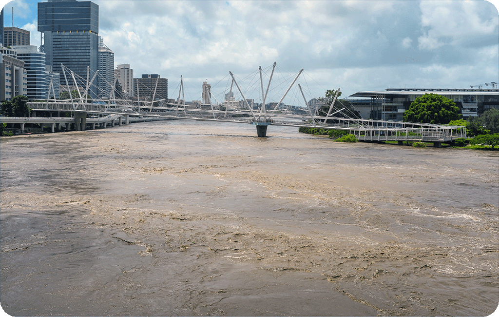 Flooded Brisbane river with Gallery of Modern Art and the City on either side