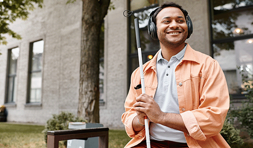 Woman with an intellectual impairment feeding her dog a treat with the help of her support worker.