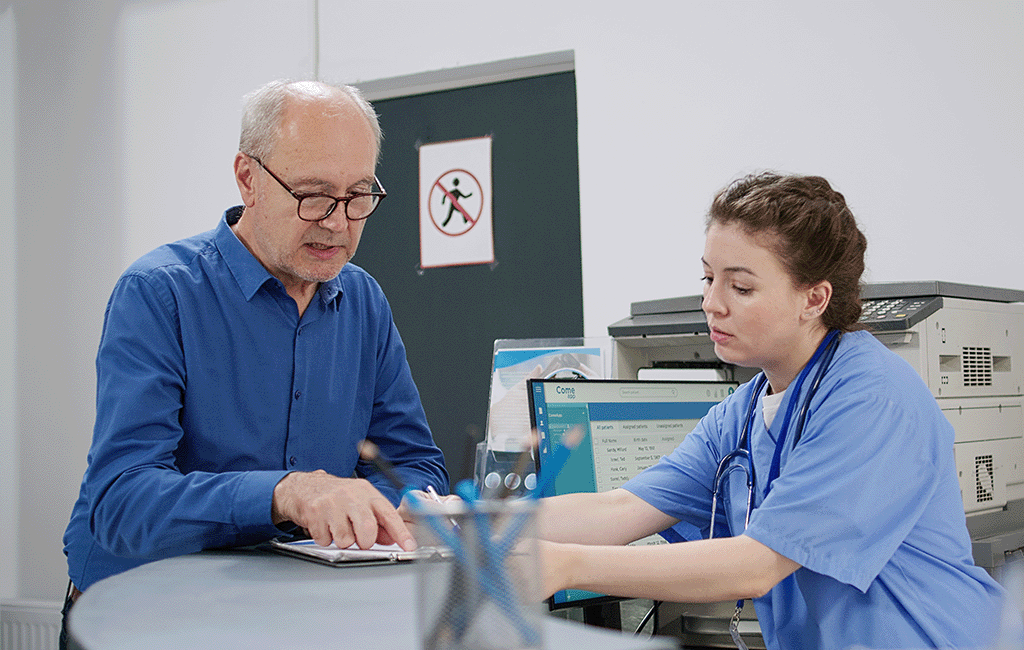 Doctor and nurse talking at nurses station